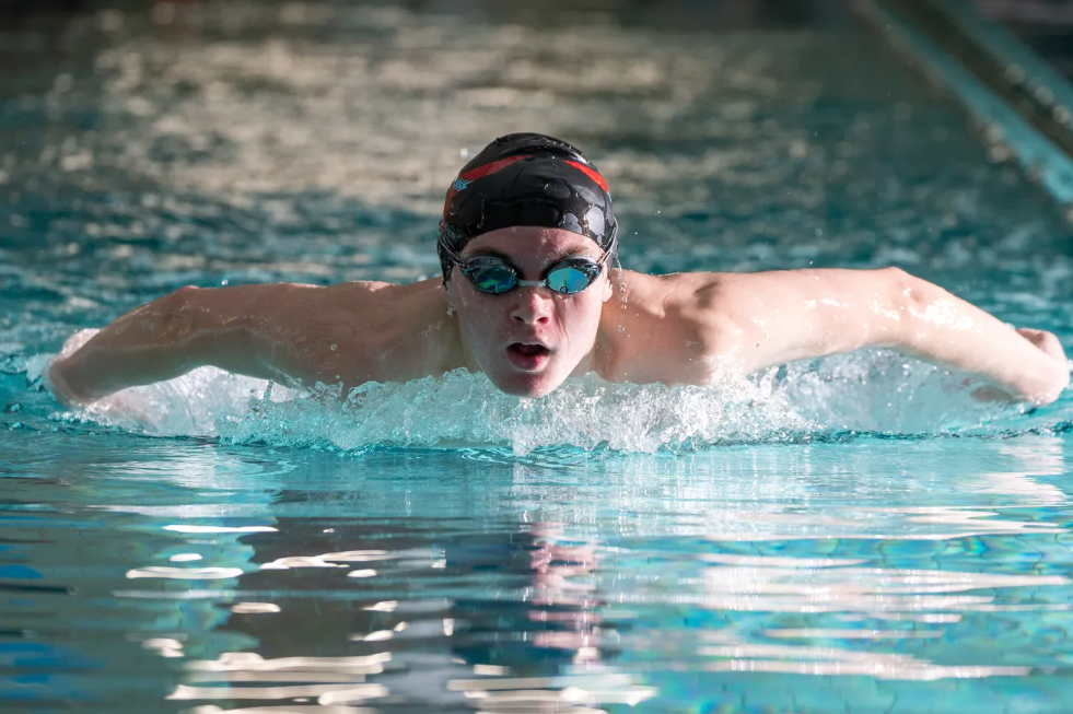 Practicing for state competitions, Shawnee Heights senior Luke Perkins works on his butterfly stroke during last Friday's practice at the YWCA downtown. Photo by Evert Nelson/The Capital-Journal